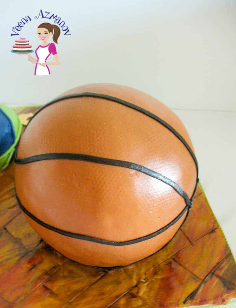A cake decorated to look like a basketball.
