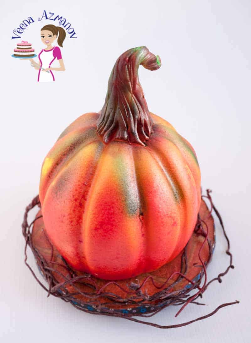 A cake decorated to look like a pumpkin.