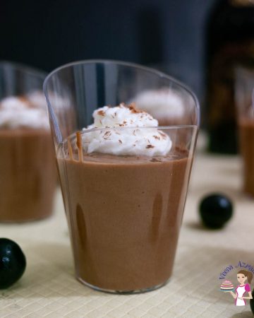 A glass with eggless chocolate mousse topped with whipped cream