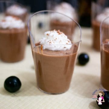 A glass of mousse topped with whipped cream