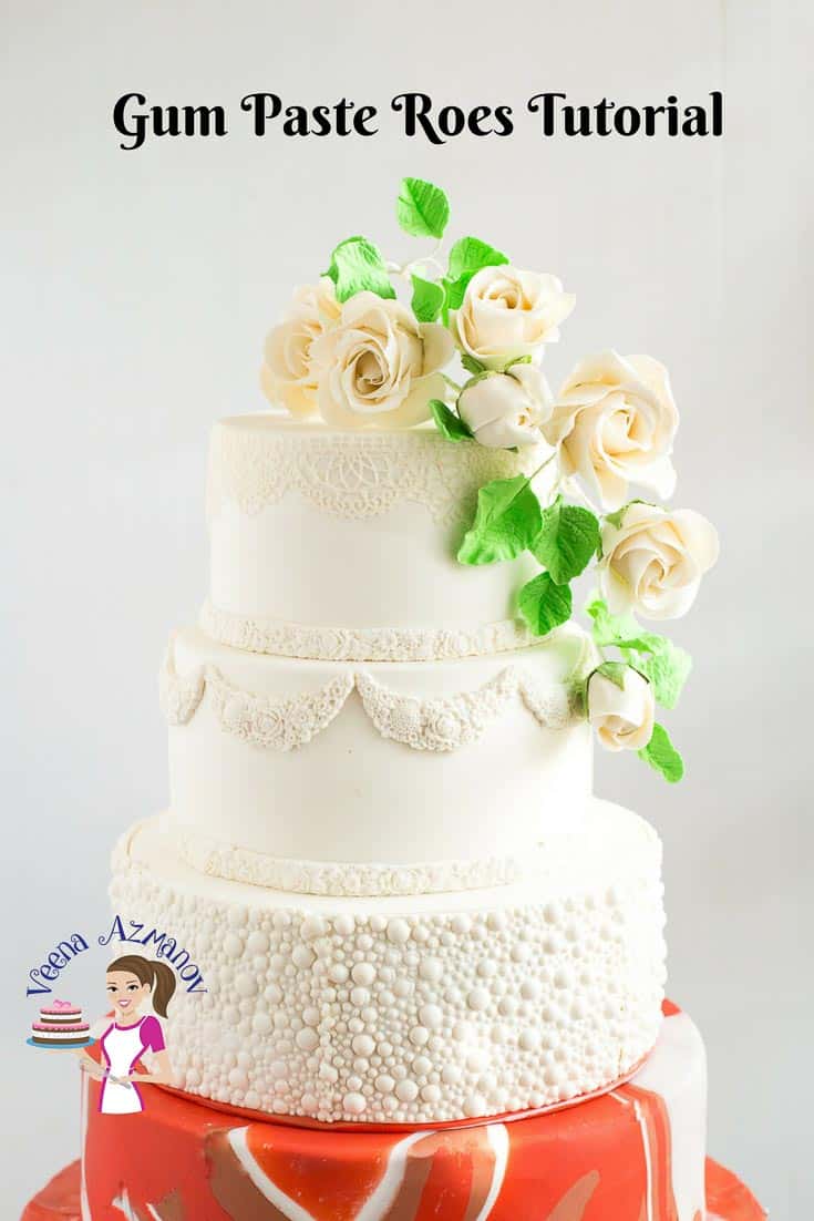 A wedding cake with white gum paste roses.