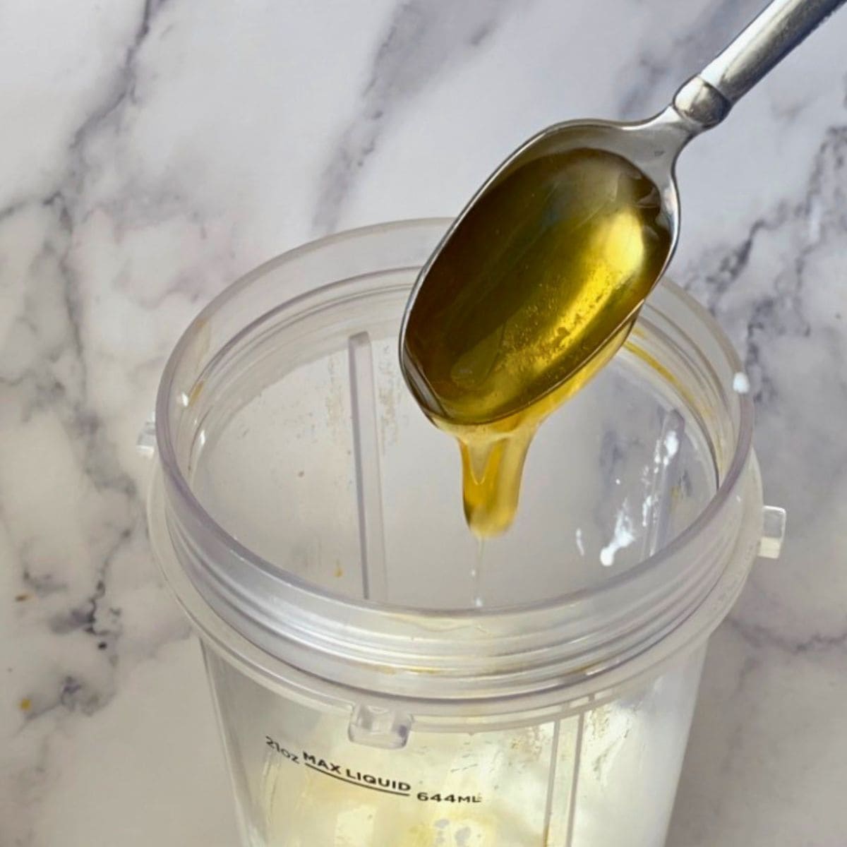 Adding Honey to the blender.