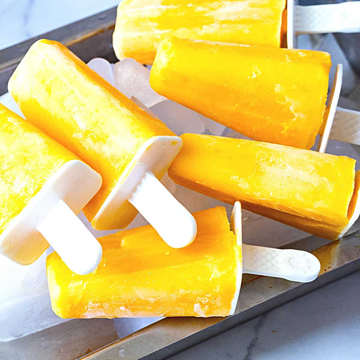 An ice tray with mango pops.
