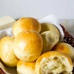 A close up of soft dinner rolls in a basket.