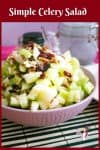 A bowl of celery salad with pecans and cranberries.
