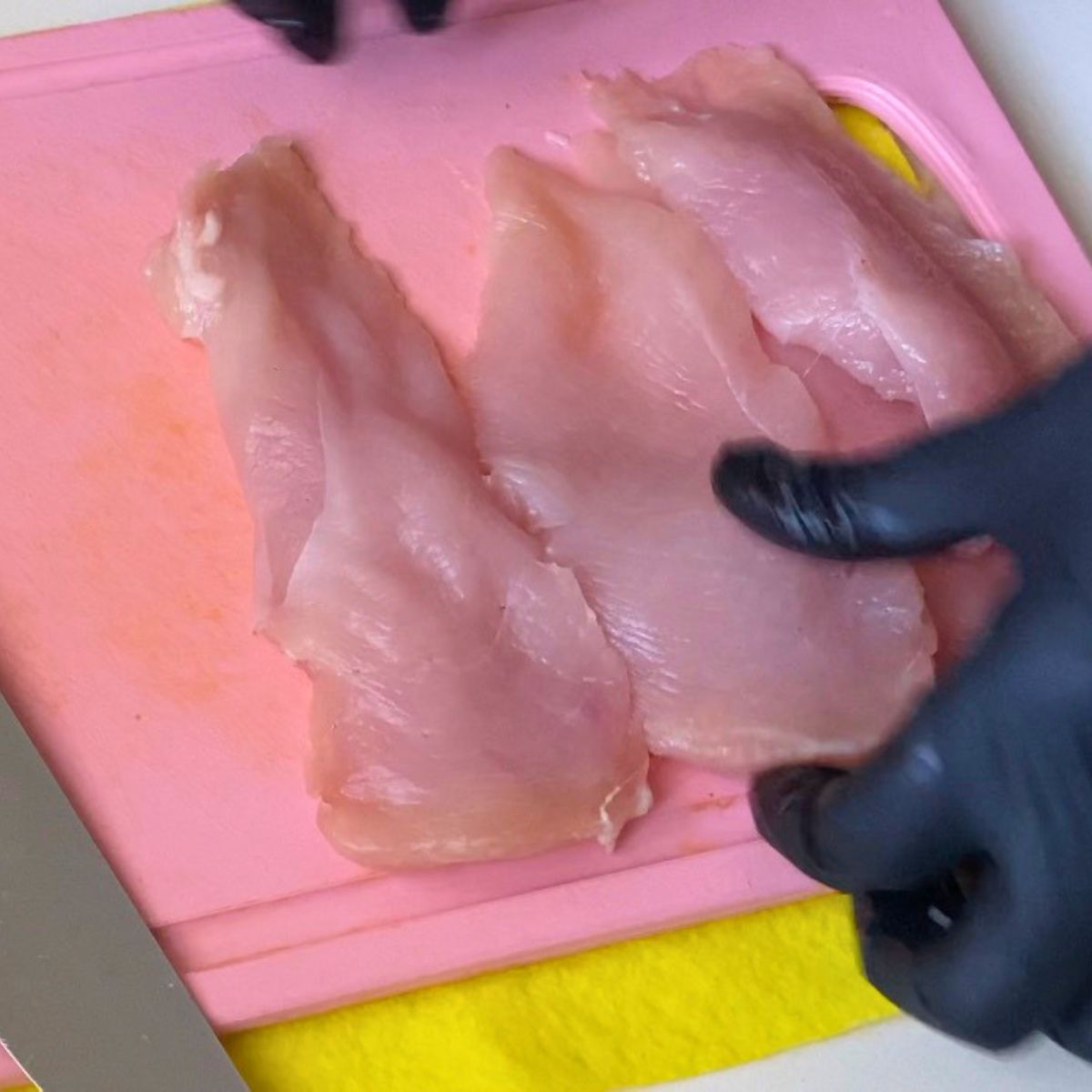 A board with chicken breast.