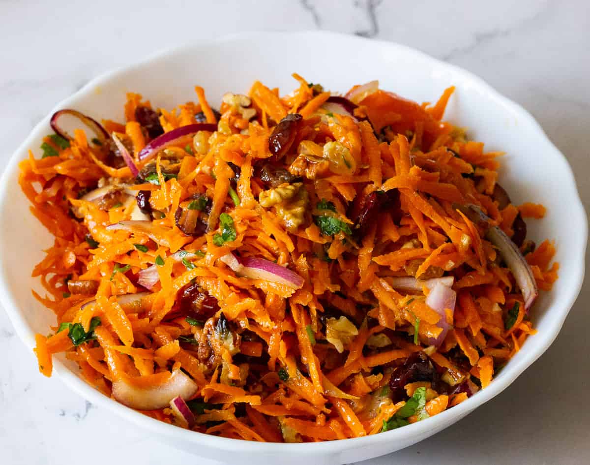 Bowl with grated carrots salad.