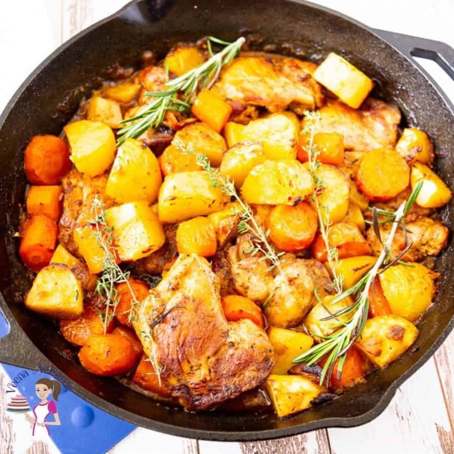 Roasted chicken and vegetables in a skillet.