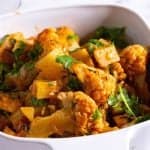 A serving dish with potato cauliflower curry.