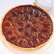 A cake stand with pecan tart.