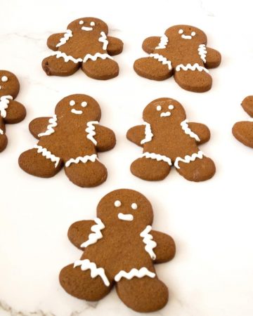 Frosted gingerbread men on a white table.
