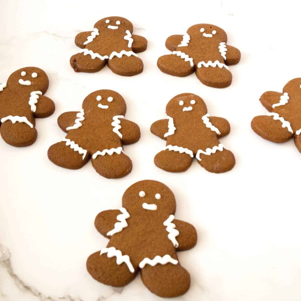 Frosted gingerbread men on a white table.