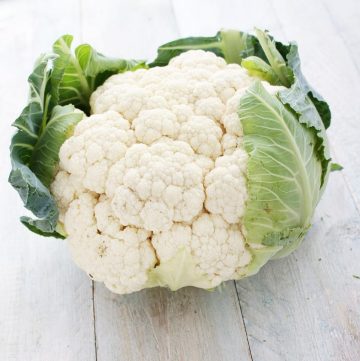 A raw whole cauliflower head