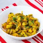 A bowl with Bombay potatoes.
