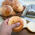 A person holding a soft hamburger bun.