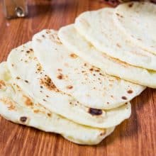 A stack of Indian naan on a table.