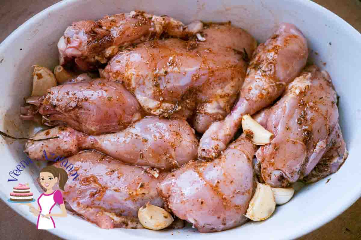 A bowl of spiced raw chicken thighs and drumsticks.