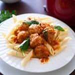 A plate with ground turkey and penne pasta.