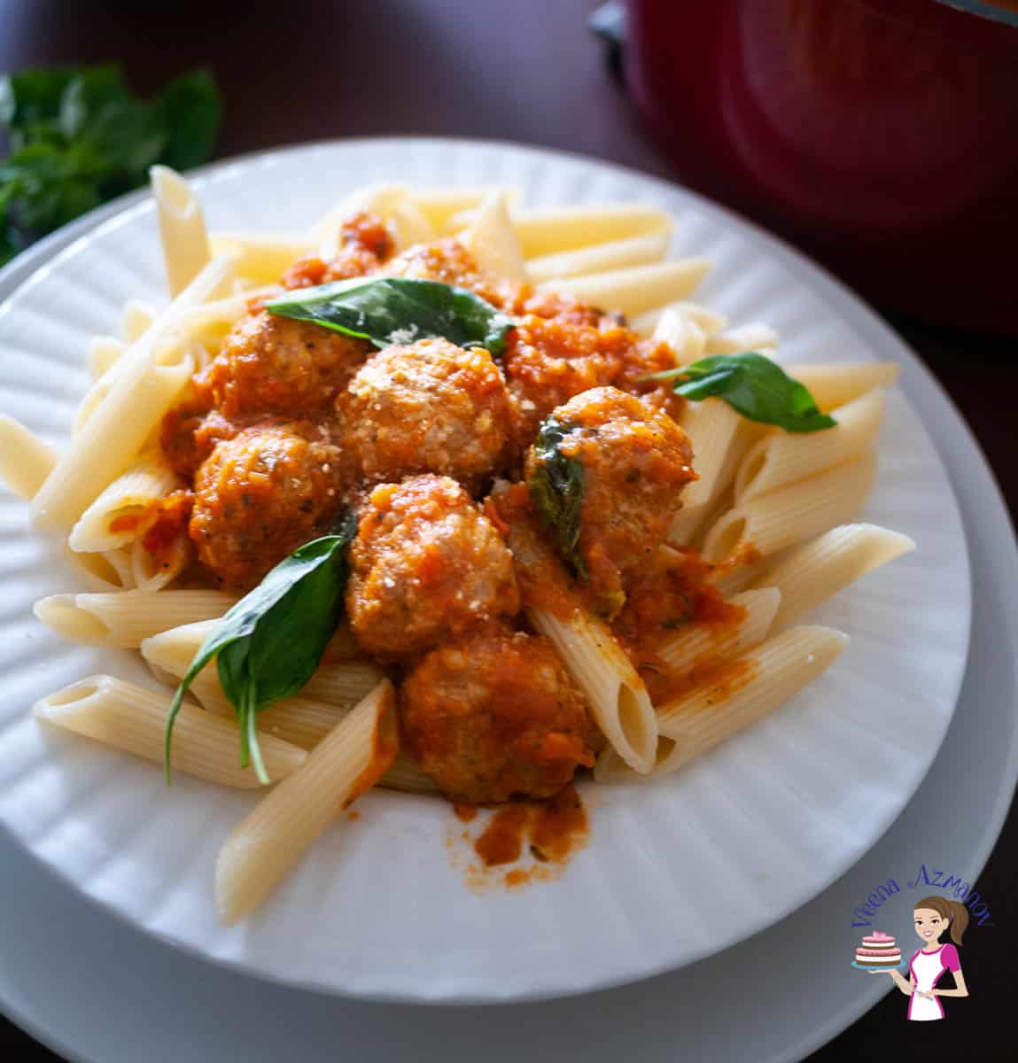 A plate of turkey meatballs with penne pasta.