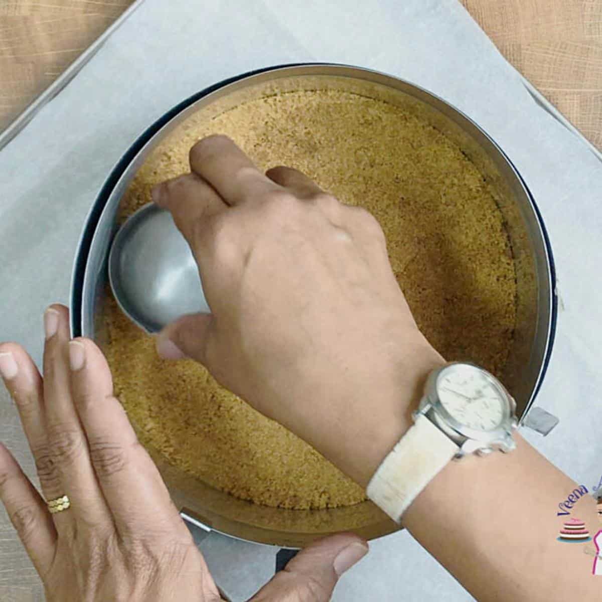 A cake ring with graham cracker crust from scratch.