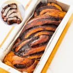 A babka on a loaf pan with chocolate.