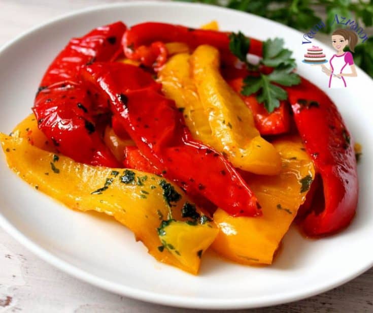 A plate with roasted red and yellow peppers.