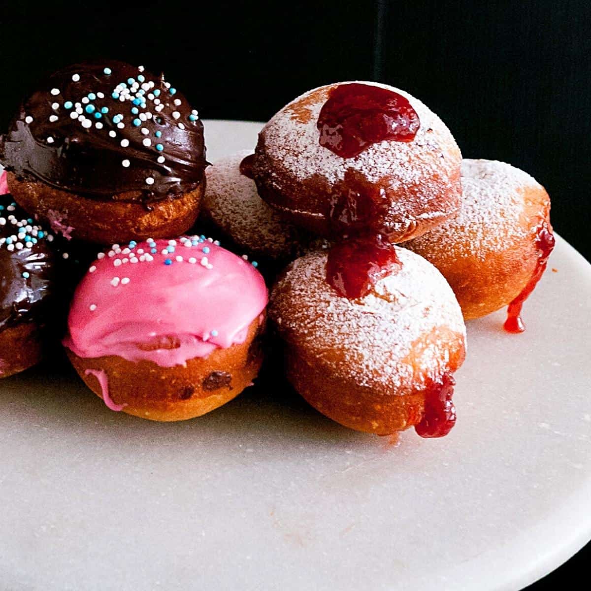 Jam doughnuts on a table.