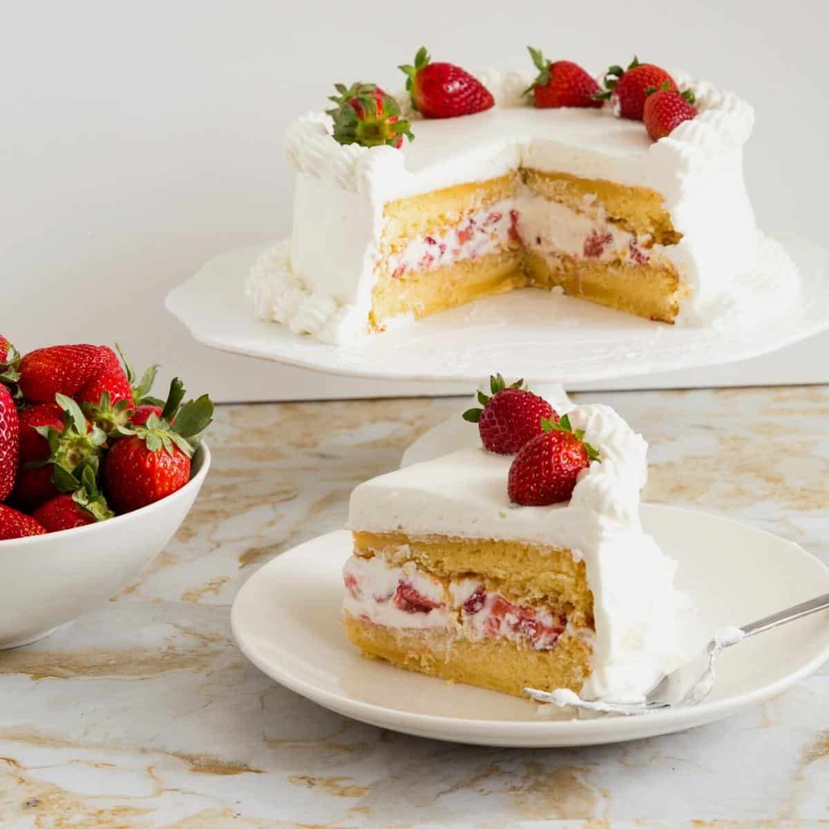 A sliced genoise cake with whipped cream.