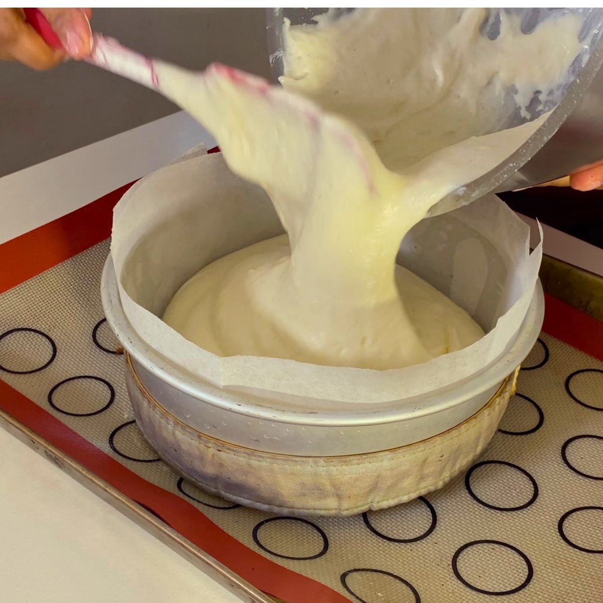 Pouring sponge batter into cake pan.