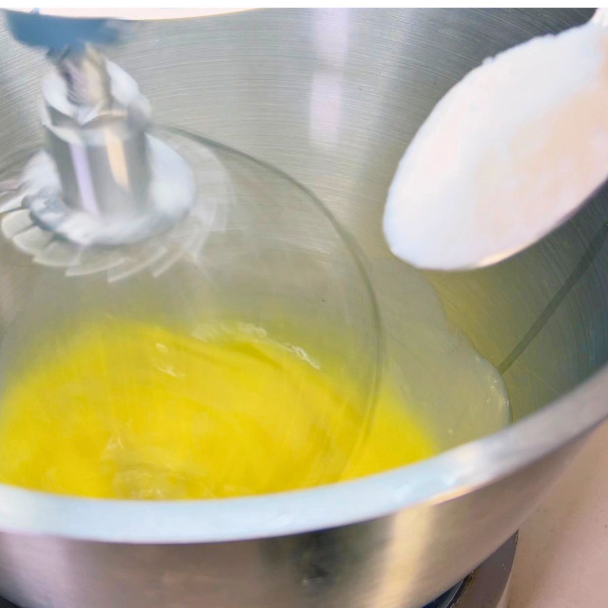 Whipping eggs with sugar in stand mixer.