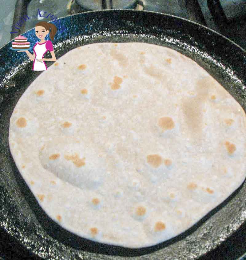 A chapati baked on a stove top.