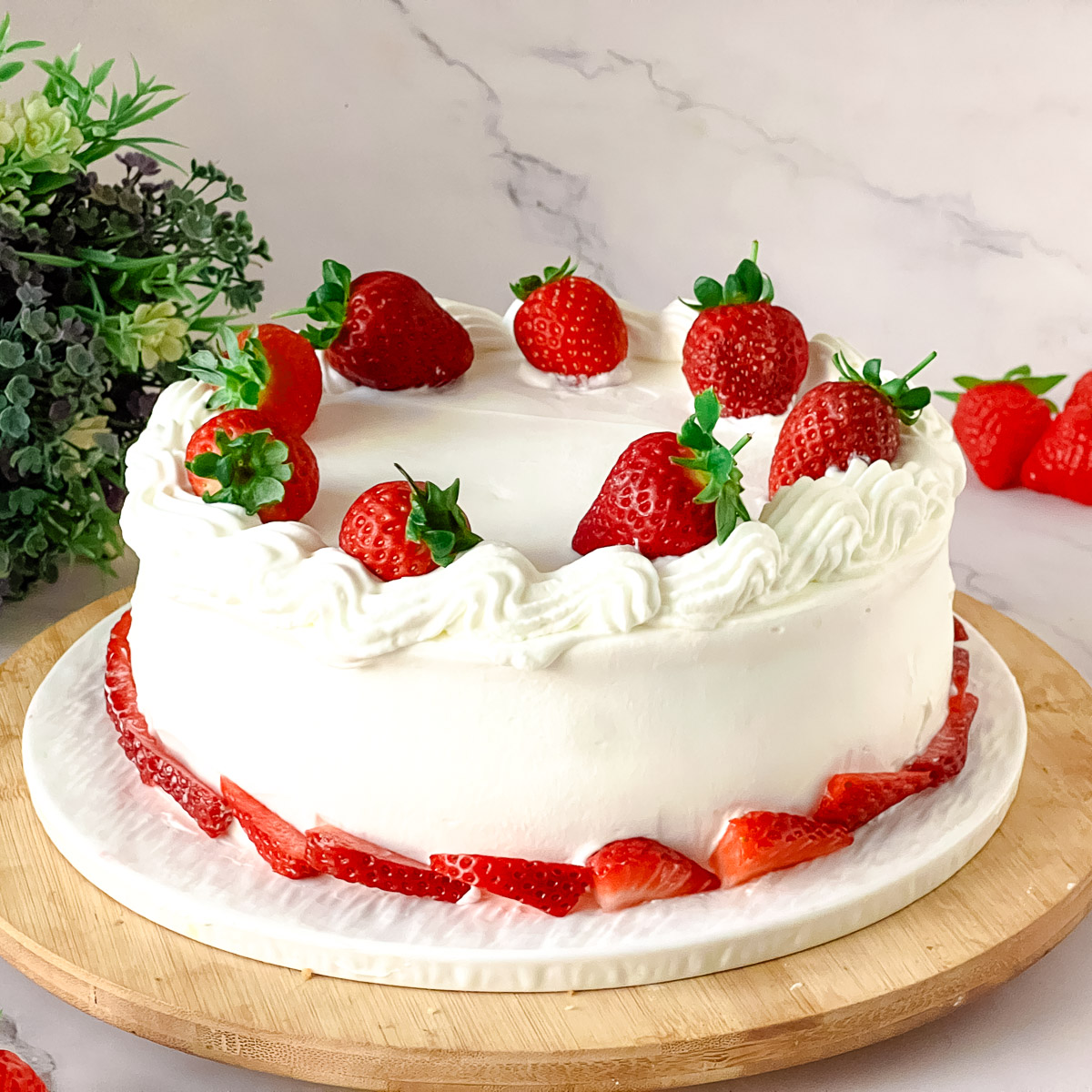 Frosted sponge cake with heavy cream and strawberries.