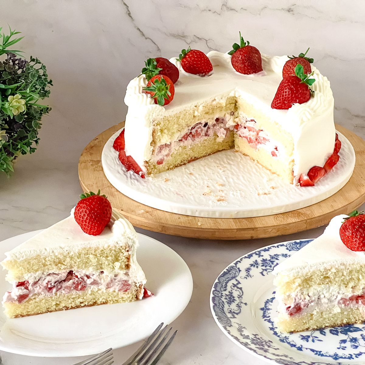 Sliced strawberry cake with whipped cream.