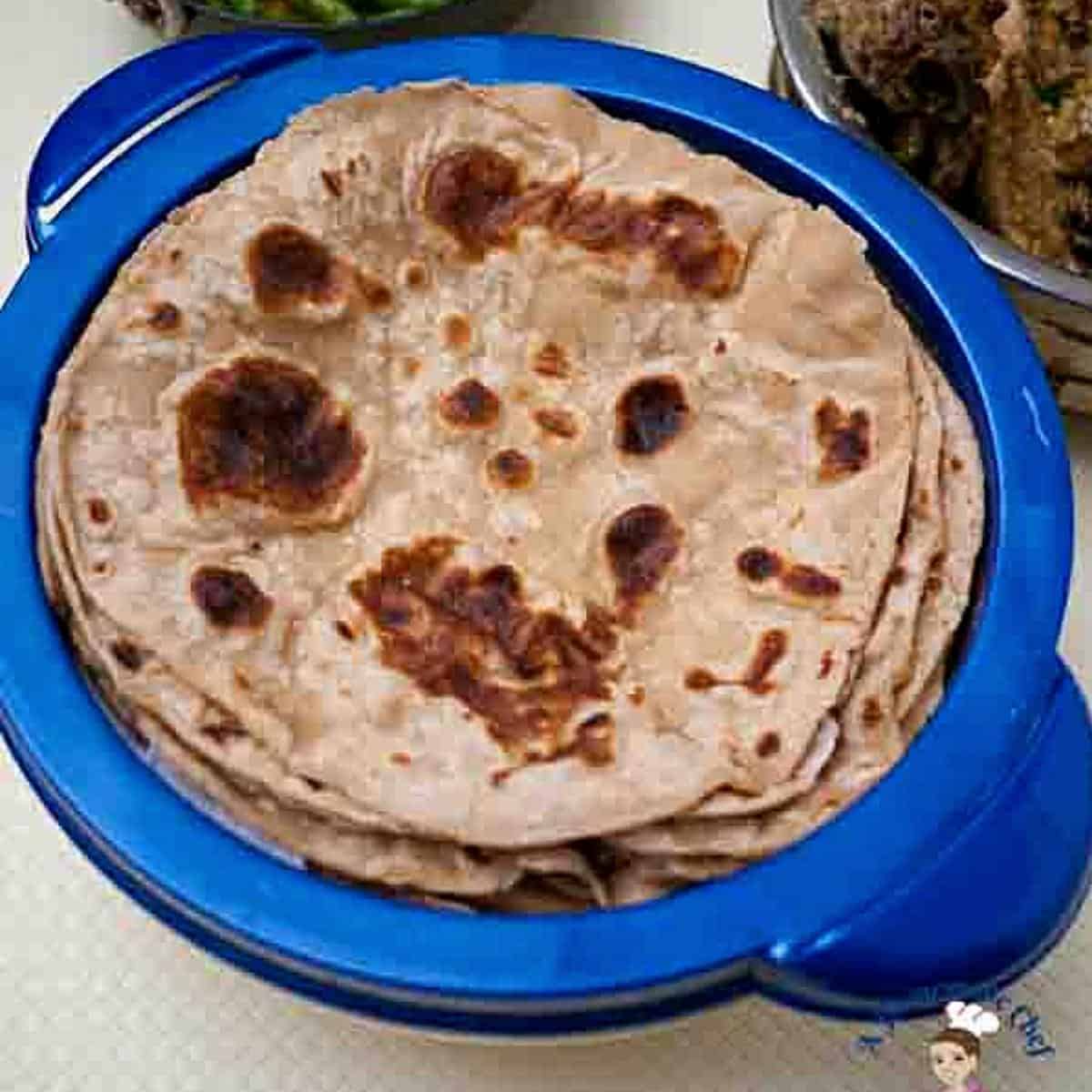 A tupperware with tortillas or chapati made with whole wheat flour. 