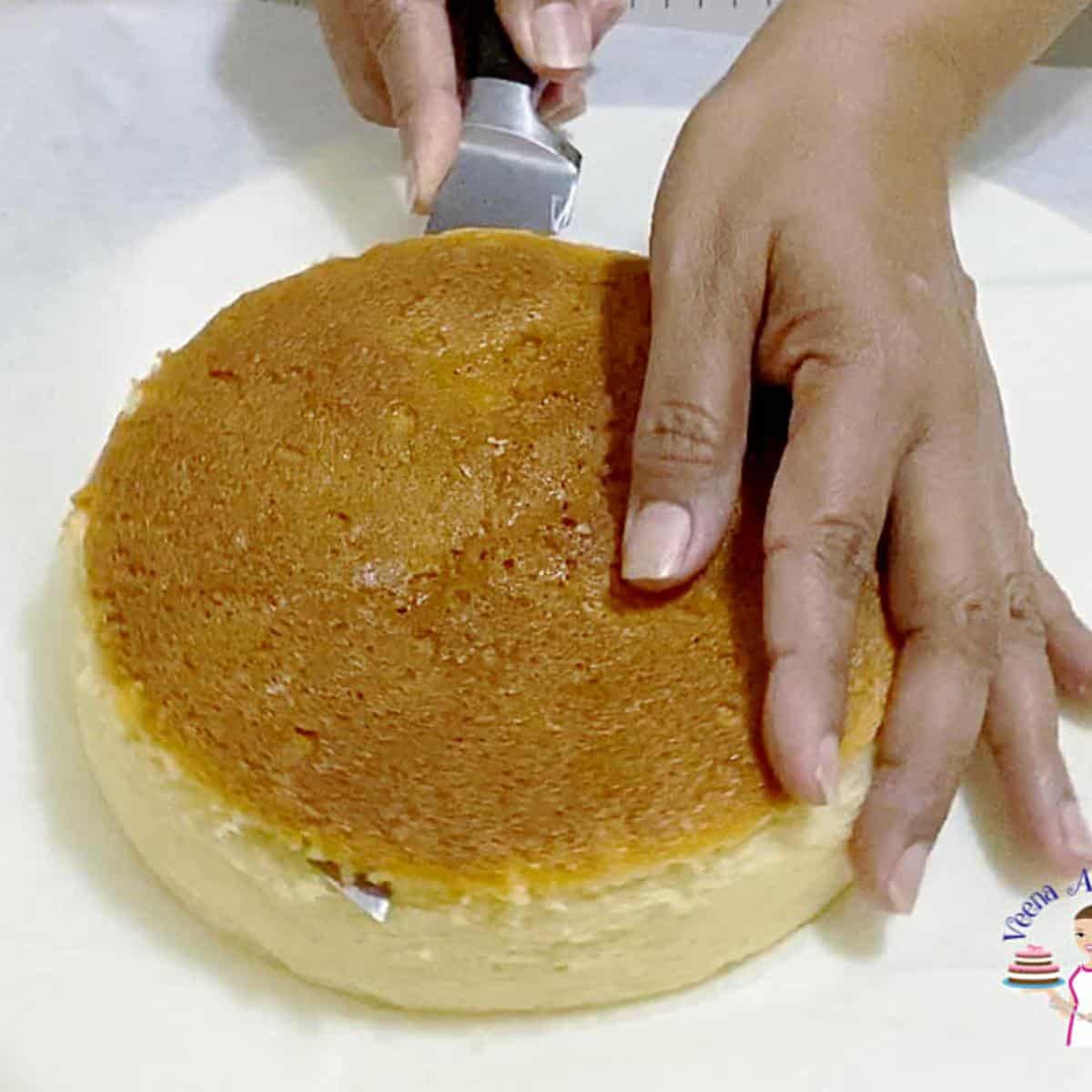 Leveling the top of a cake layer.