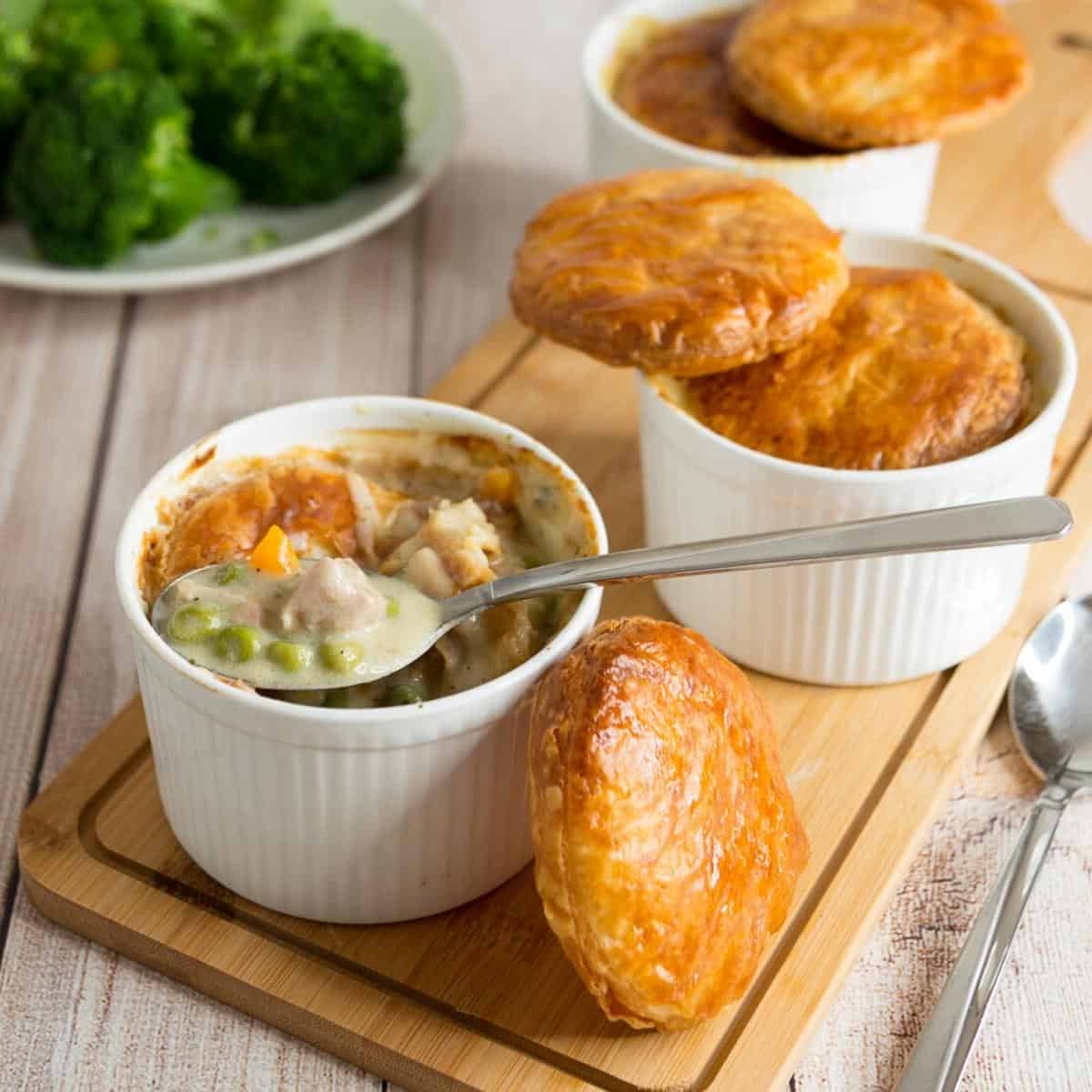 A ramekin with pot pie and puff pastry.