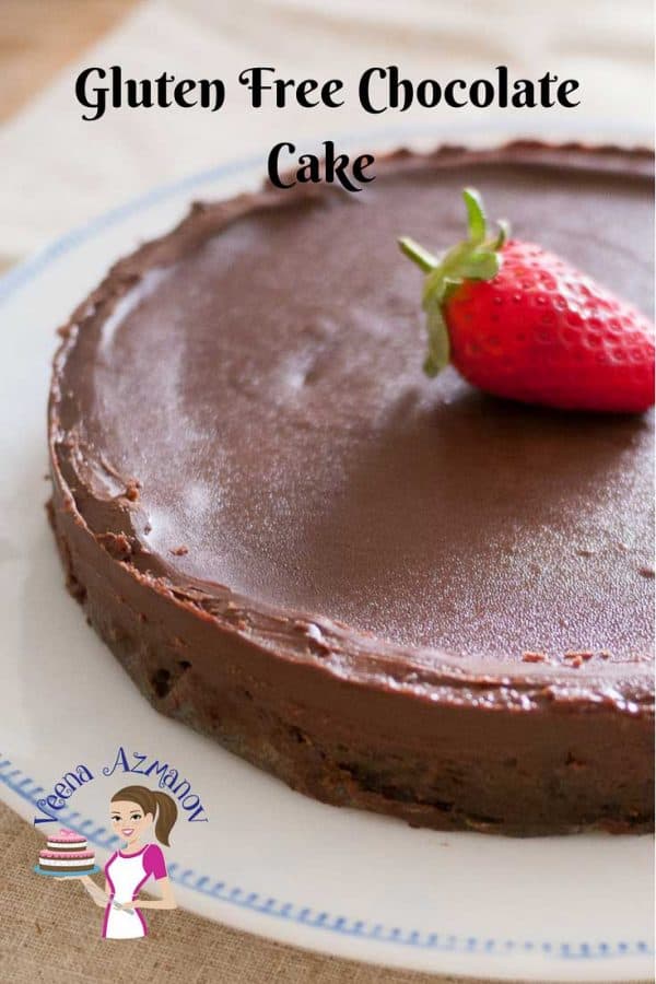 An image optimized for social media sharing for this flourless chocolate cake aka gluten free chocolate cake. Showing the full cake garnished with a strawberry.