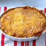 A baking dish with bubbling meat pie.
