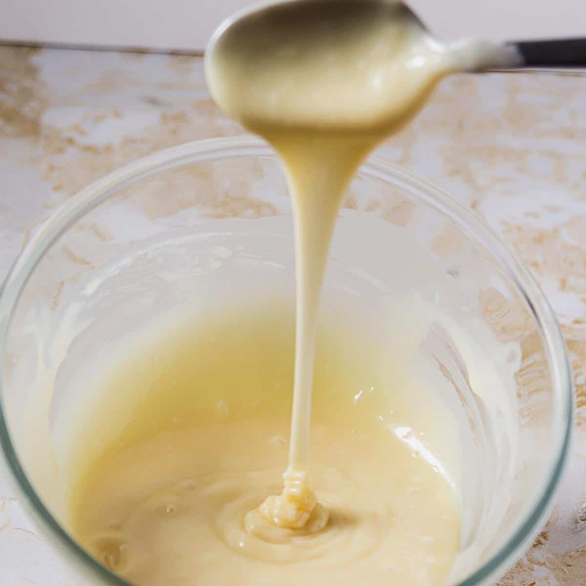 A bowl with white chocolate ganache drip.