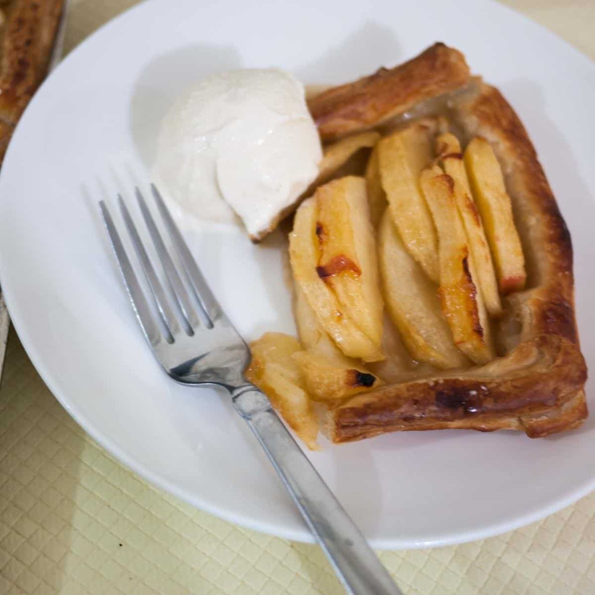A piece of apple tart with ice cream.