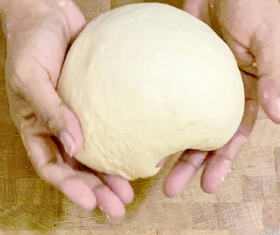 A person holding yeast dough.