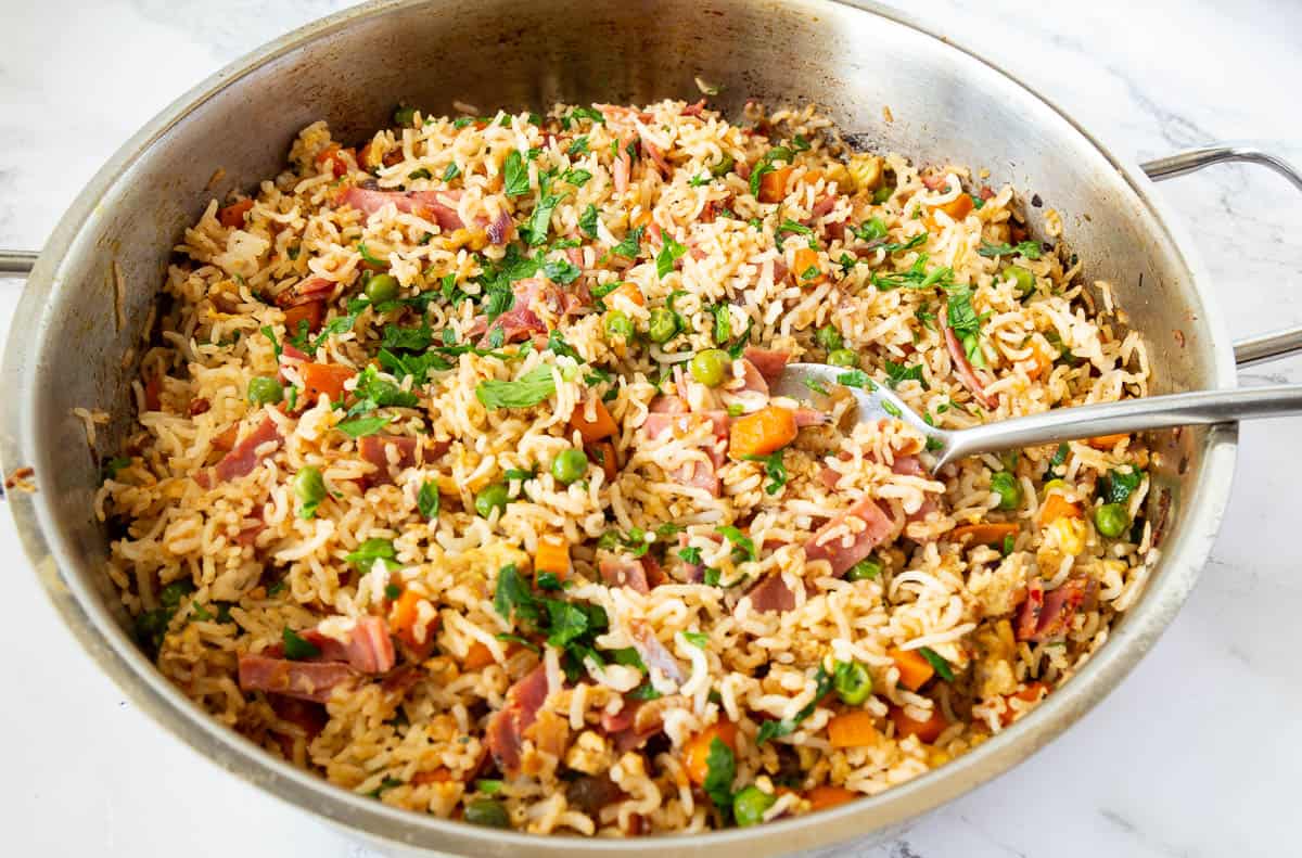 A skillet with one pot fried Asian rice.