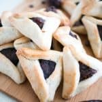 Filled cookies on a wooden board