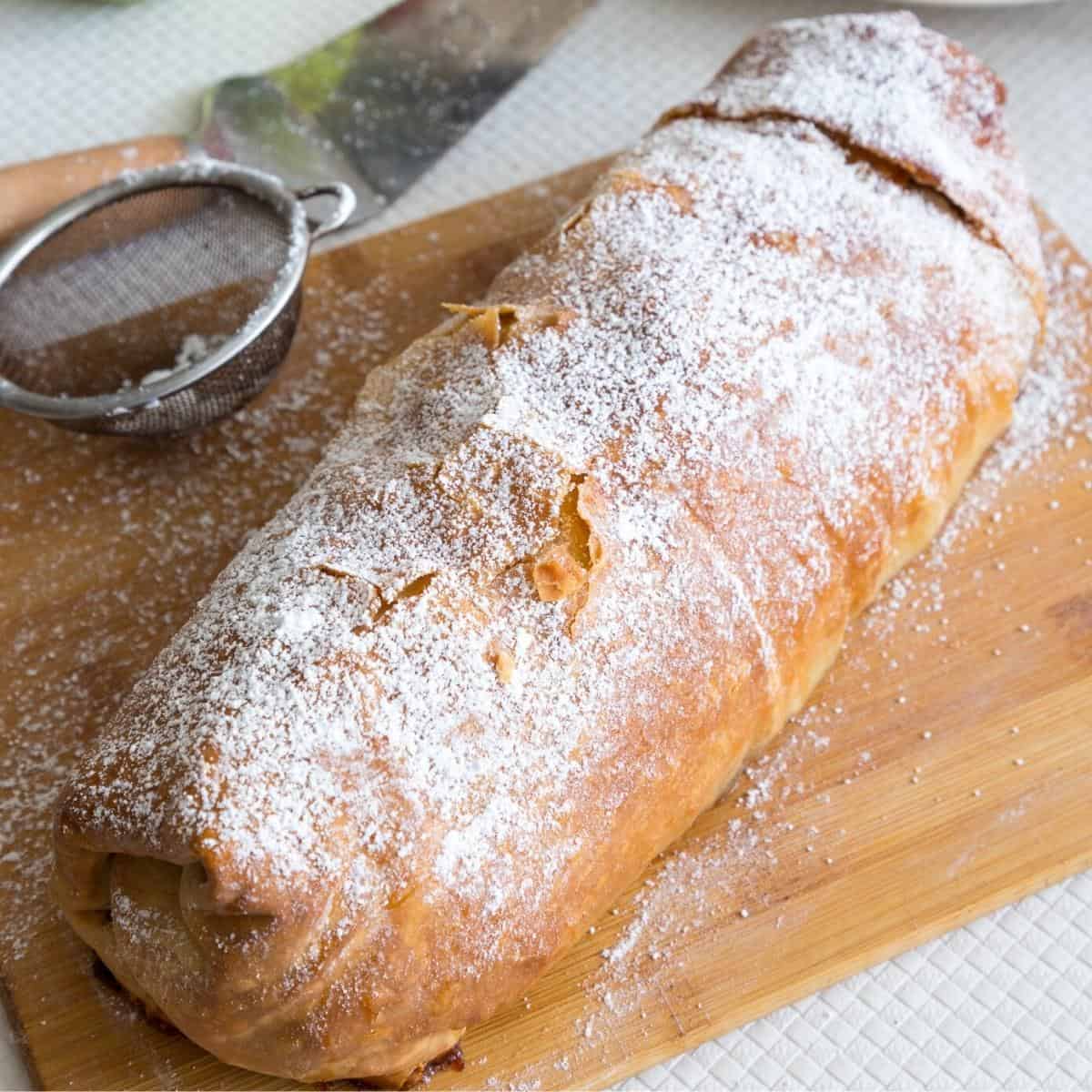 A baked apple strudel on the table.