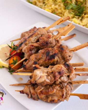 A stack of Thai chicken skewers on a plate.