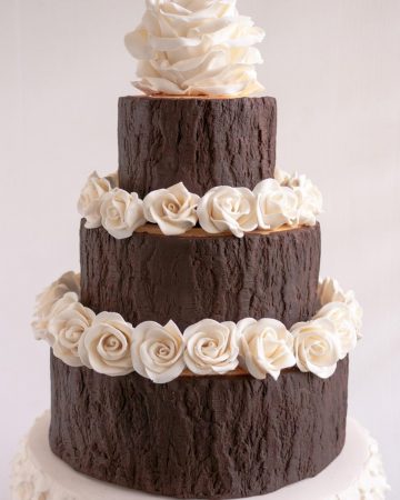 A three tier cake covered with modeling chocolate.