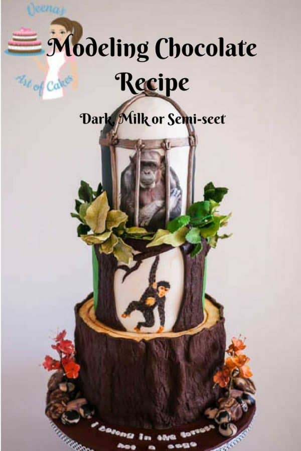 A cake decorated to look like a chimpanzee on a tree and in a cage.