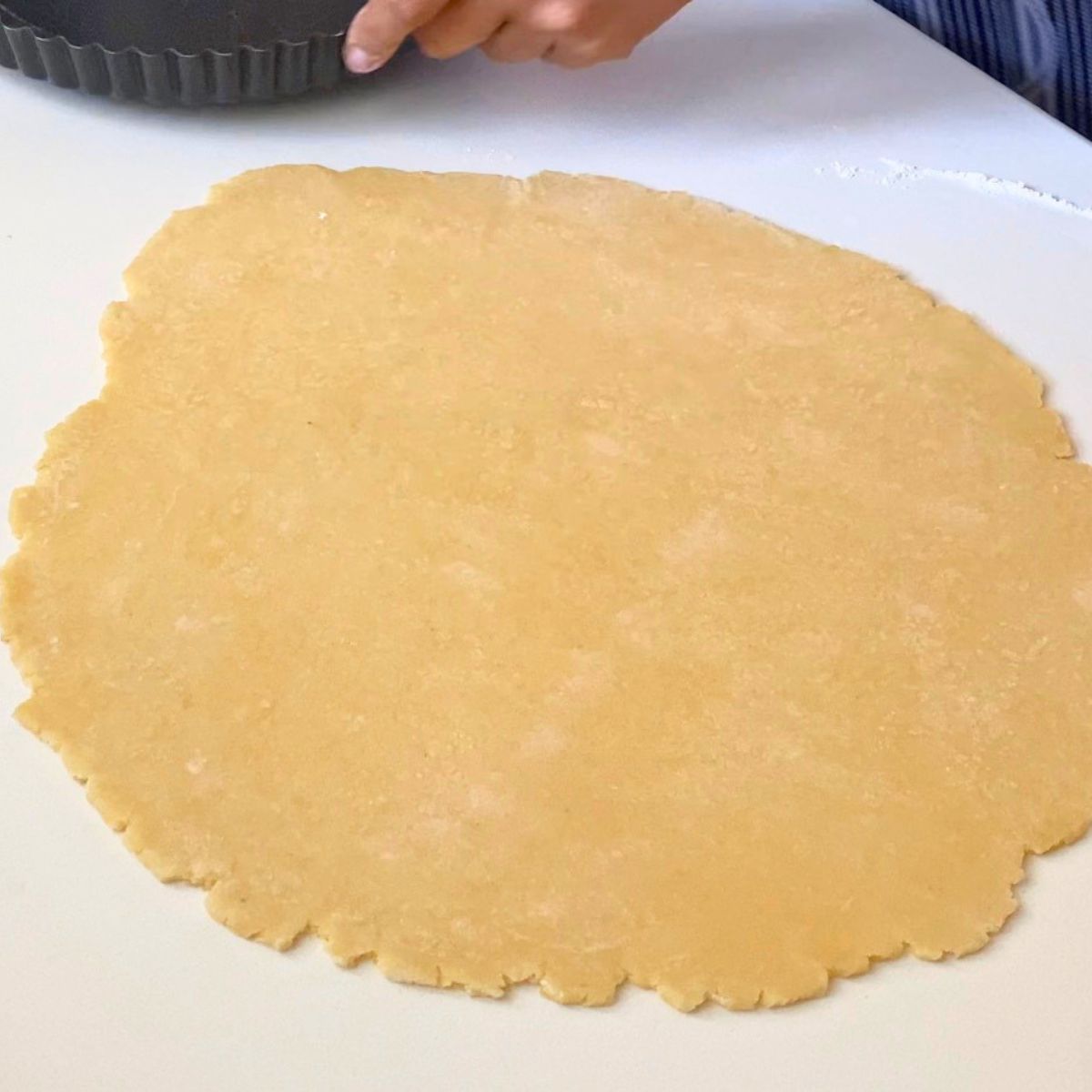 Rolling the pastry dough into a sheet.