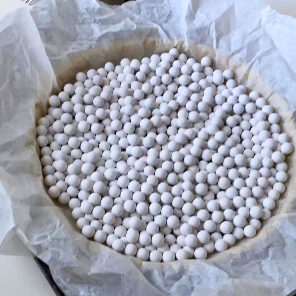 Baking a tart shell with pie weights.