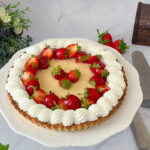 A cake stand with pastry cream and whipped cream.